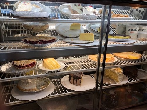 Pies and cheesecakes in a glass case at Twin Pines Diner