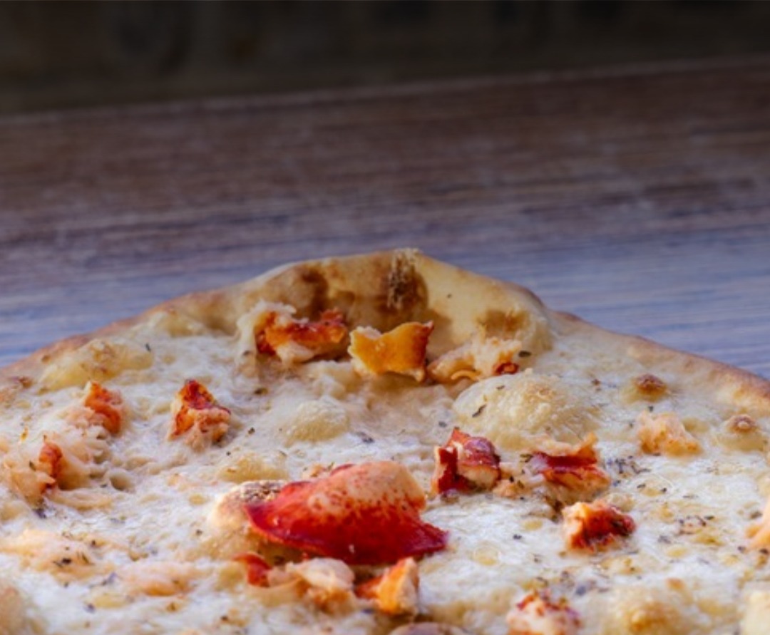 A white pizza topped with lobster meat from Sandpiper Restaurant